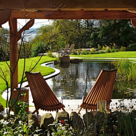 View through the arbour across the pond. Garden designed by Carolyn Grohmann