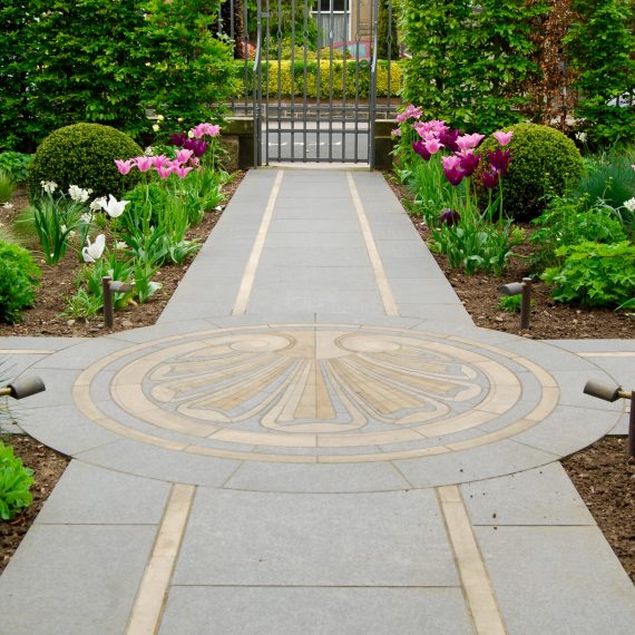 Black basalt paving with Clashach inlay and cut stone mosaic by Joel Baker. Garden designed by Carolyn Grohmann