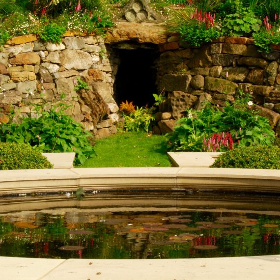 Formal raised water feature with grotto in background, garden designed by Carolyn Grohmann