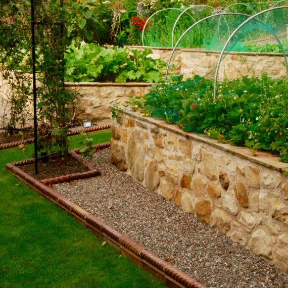 Raised stone vegetable beds, designed by Carolyn Grohmann
