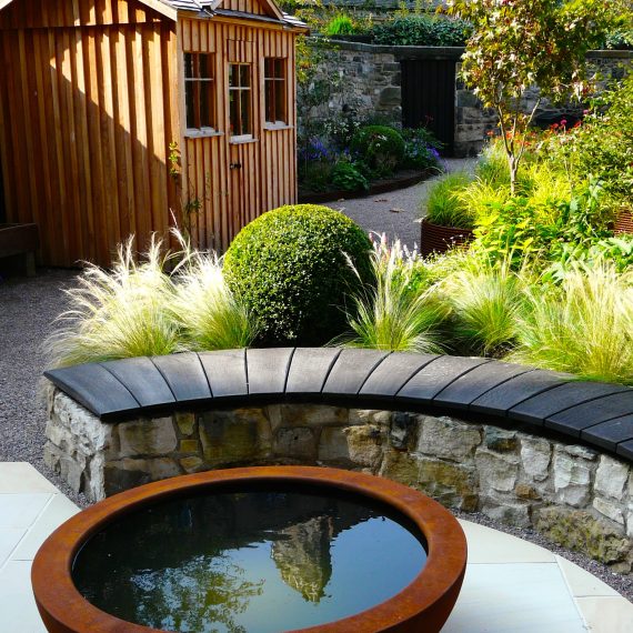 Urbis lily bowl, scorched oak bench, garden designed by Carolyn Grohmann