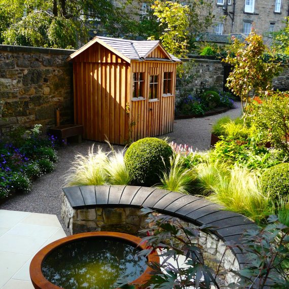 Urbis lily bowl, scorched oak bench, garden designed by Carolyn Grohmann