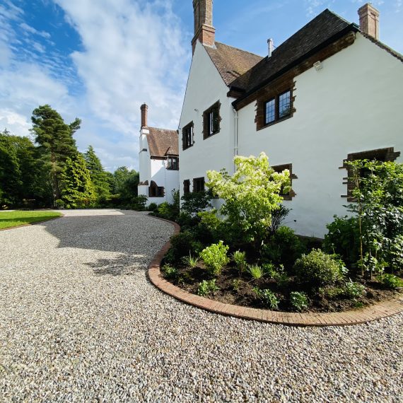 Front of house driveway with large borders