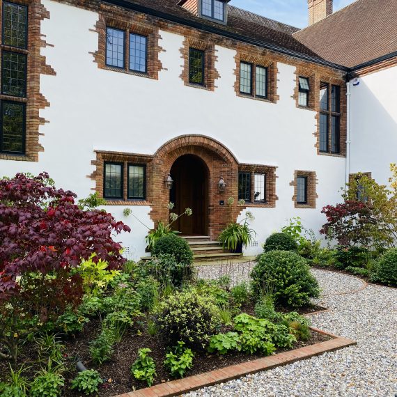 Arts and Crafts house with heavily planted borders