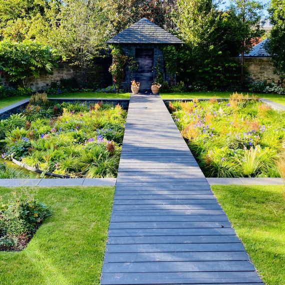 Timber boardwalk and stone garden building