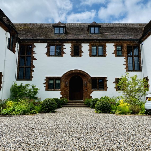 Arts and Crafts house with heavily planted borders