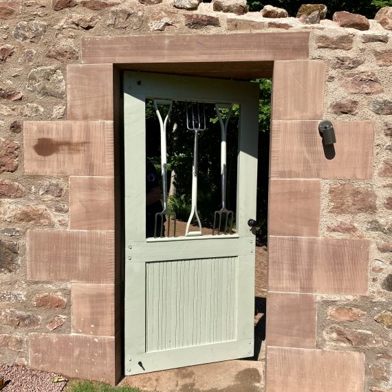 Garden fork gate leading to walled kitchen garden