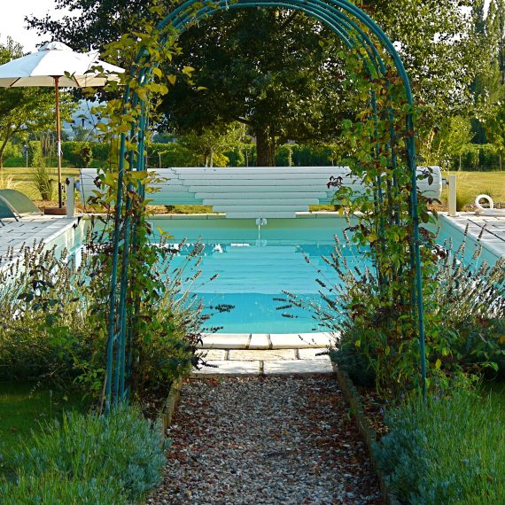 Rose arch leading to pool