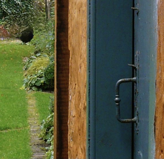 Garden designed by Carolyn Grohmann, brick edging, lime washed garden building, herbaceous planting