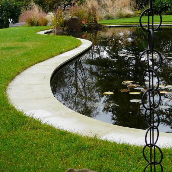 Curving stone edging around wildlife pond