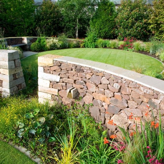 Serpentine garden curving wall, designed by Carolyn Grohmann