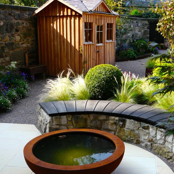 Curved stone wall, oak bench top and Urbis lily bowl