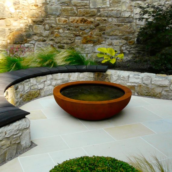 Urbis lily bowl, scorched oak bench, garden designed by Carolyn Grohmann