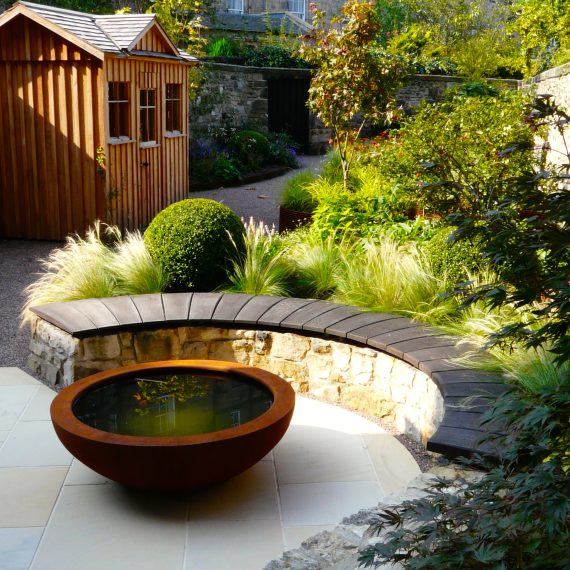 Curved stone wall, oak bench top, Urbis lily bowl