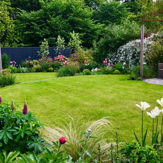 Larch and rebar pergolas, circular lawns and lush herbaceous planting designed by Carolyn Grohmann