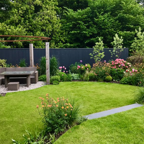 Larch and rebar pergolas, circular lawns and lush herbaceous planting designed by Carolyn Grohmann