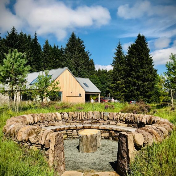 The 'Sheep Pen' seating area made with local stone and Scottish larch bench. Designed by Carolyn Grohmann