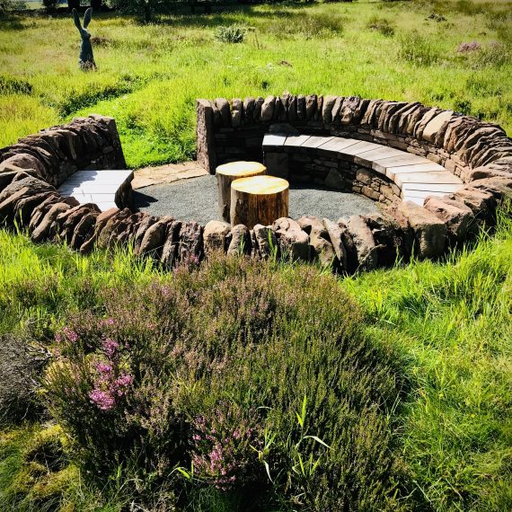 The 'Sheep Pen' seating area made with local stone and Scottish larch bench. Designed by Carolyn Grohmann