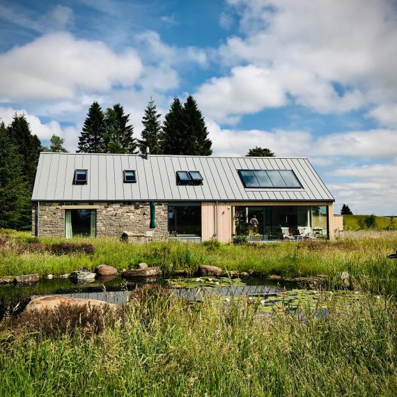 View across the pond to the house, overseen by the heron. Garden designed by Carolyn Grohmann