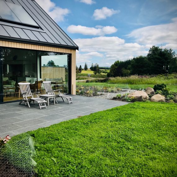 South-west facing patio with recently planted borders and species rich turf. Designed by Carolyn Grohmann