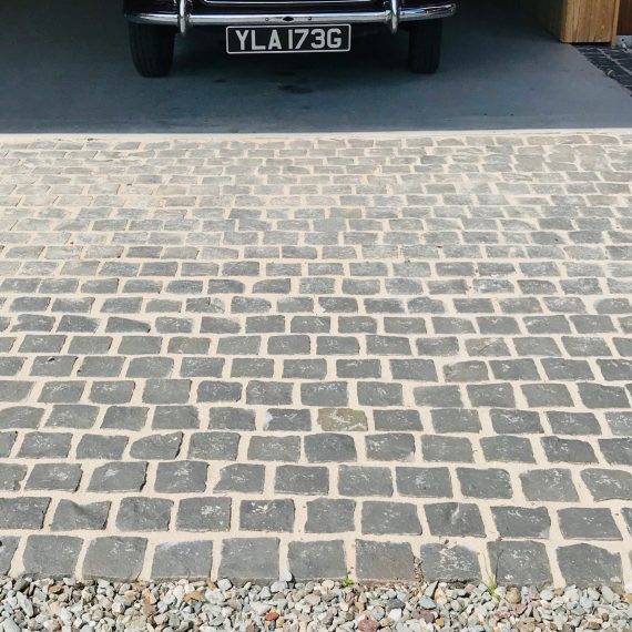 Carport entrance: black basalt setts and gravel stabilisation system. Designed by Carolyn Grohmann