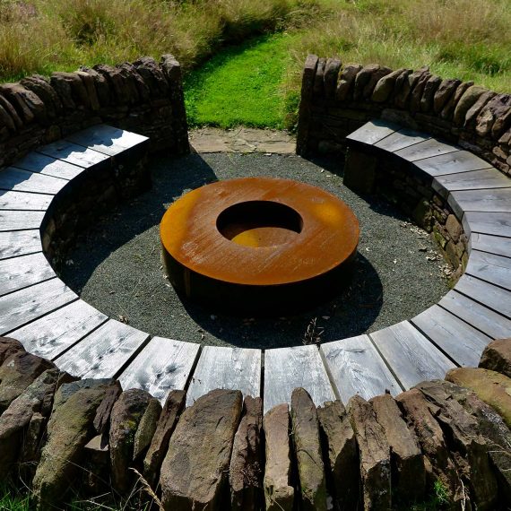 The 'Sheep Pen' seating area made with local stone and Scottish larch bench. Designed by Carolyn Grohmann