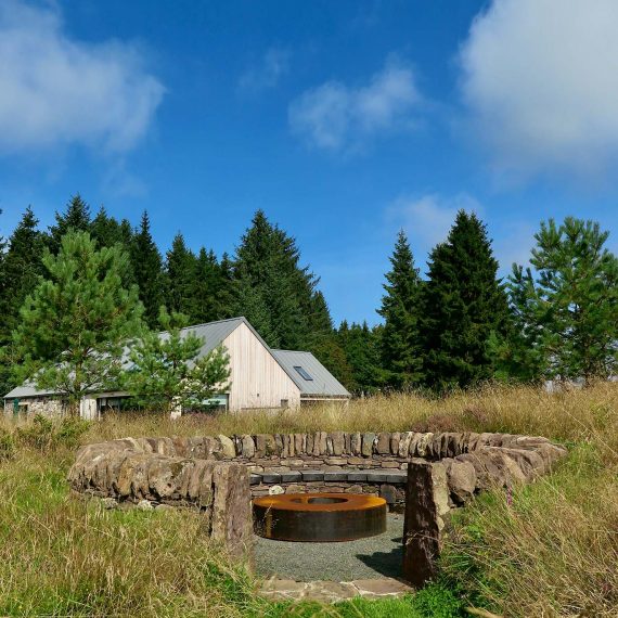 The 'Sheep Pen' seating area made with local stone and Scottish larch bench. Designed by Carolyn Grohmann