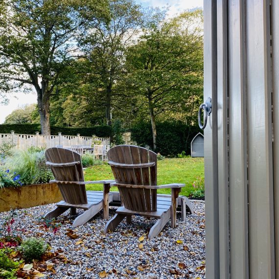 Adirondack chairs, garden designed by Carolyn Grohmann