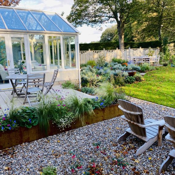 Millboard deck, Adirondack chairs, garden design by Carolyn Grohmann