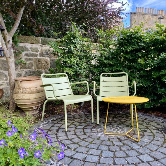 Fermob Luxembourg chairs and black granite sett patio